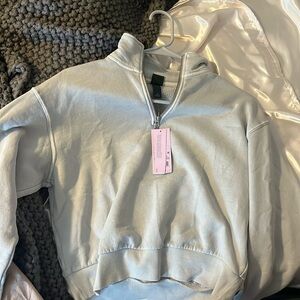 Light grey cropped target sweatshirt.